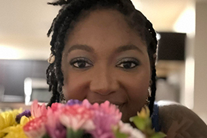 Dr. Charne Ellis in front of flowers